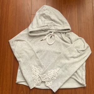 Short hoodie with cute design on the sleeves (like new)